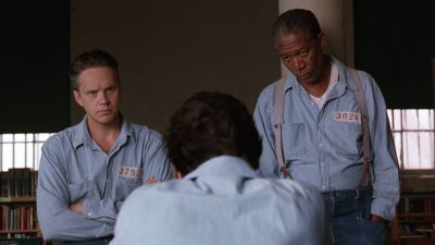 Still from The Shawshank Redemption (1994) that has been tagged with: interior & three-shot & over-the-shoulder & medium wide