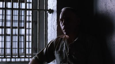 Still from The Shawshank Redemption (1994) that has been tagged with: prison cell & medium shot & interior & clean single & day