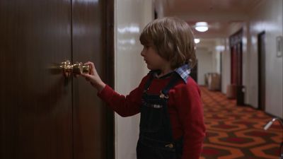 Still from The Shining (1980) that has been tagged with: 6e1c1c & hotel & hallway & day & clean single