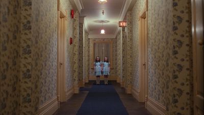 Still from The Shining (1980) that has been tagged with: two-shot & hallway & interior & twins & wide shot & day