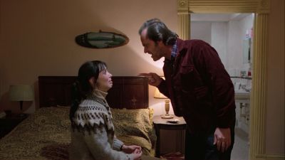 Still from The Shining (1980) that has been tagged with: interior & two-shot & profile shot & medium wide & hotel room