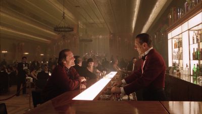 Still from The Shining (1980) that has been tagged with: wide shot & bar & bartender & group-shot & night & interior