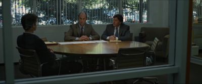 Still from The Social Network (2010) that has been tagged with: wide shot & day & interior & over-the-shoulder & conference room