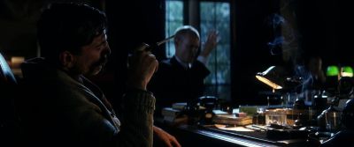 Still from There Will Be Blood (2007) that has been tagged with: smoking & period & practical lamp & historical & medium shot & sign language