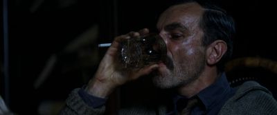 Still from There Will Be Blood (2007) that has been tagged with: profile shot & medium close-up & drinking & smoking & whiskey & clean single