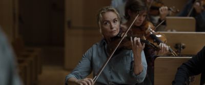Still from Tár (2022) that has been tagged with: violin & auditorium & orchestra & interior