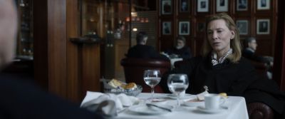 Still from Tár (2022) that has been tagged with: interior & eating & medium shot & restaurant