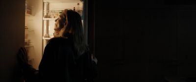 Still from Tár (2022) that has been tagged with: profile shot & night & medium shot & clean single