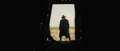 Still from True Grit (2007) that has been tagged with: frame in a frame & clean single & interior & exterior & wide shot