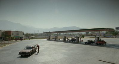 Still from Y Tu Mamá También (2001) that has been tagged with: car & gas station & extreme wide & day